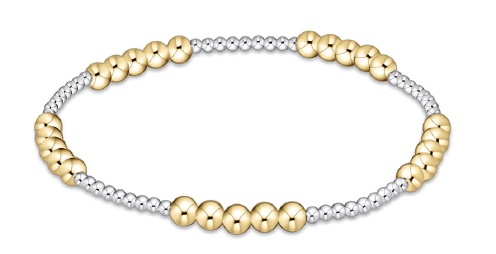 A bracelet with alternating sections of gold and silver beads.