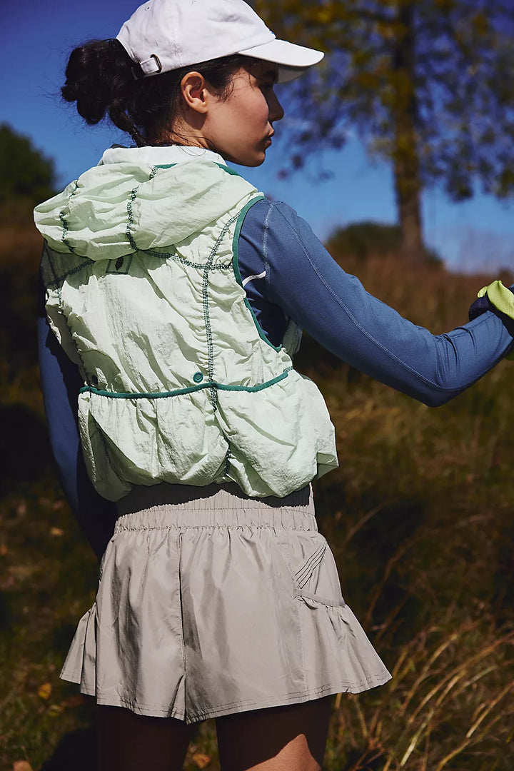 Sage Stone Get Your Flirt On Shorts with a light green vest and blue long-sleeve top.
