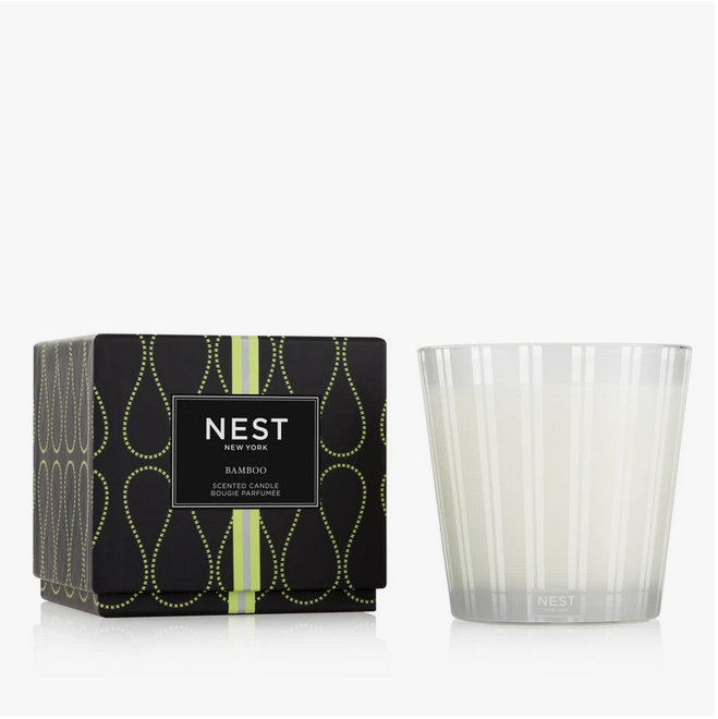 A Nest New York Bamboo scented candle in a black box and a clear glass holder.