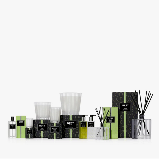 A collection of Nest New York Bamboo home fragrance products, including candles, diffusers, and soaps.