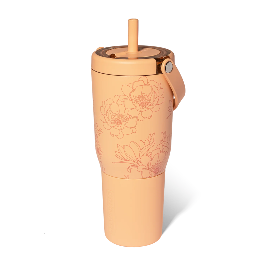 A peach-colored 35oz leakproof tumbler with a floral design and a handle.