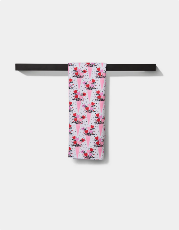 Love Bouquet Tea Towel with a pattern of pink cones filled with hearts and dots.