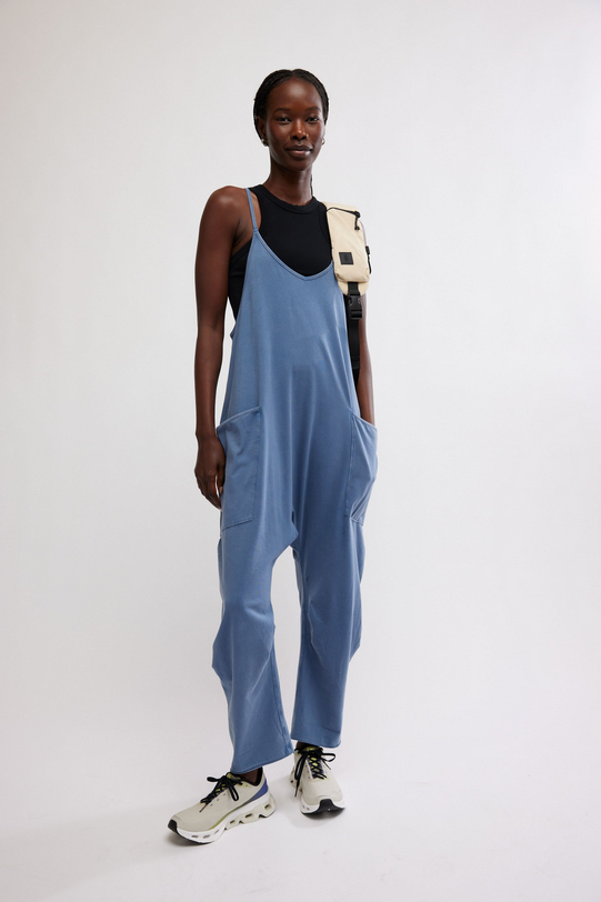 Hot Shot Onesie Skyline in blue with a black top and a beige shoulder bag.