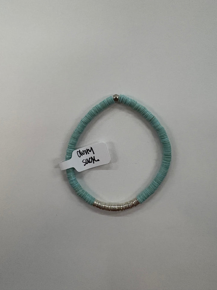 A light blue flat bead bracelet with a silver bead and silver rings.
