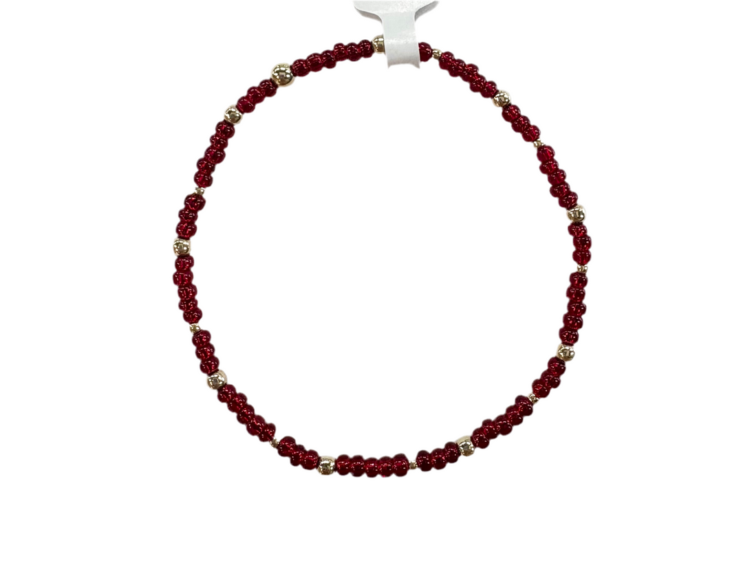 Glass bead bracelet with alternating red beads and gold-filled accents.