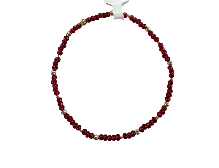 Glass bead bracelet with alternating red beads and gold-filled accents.