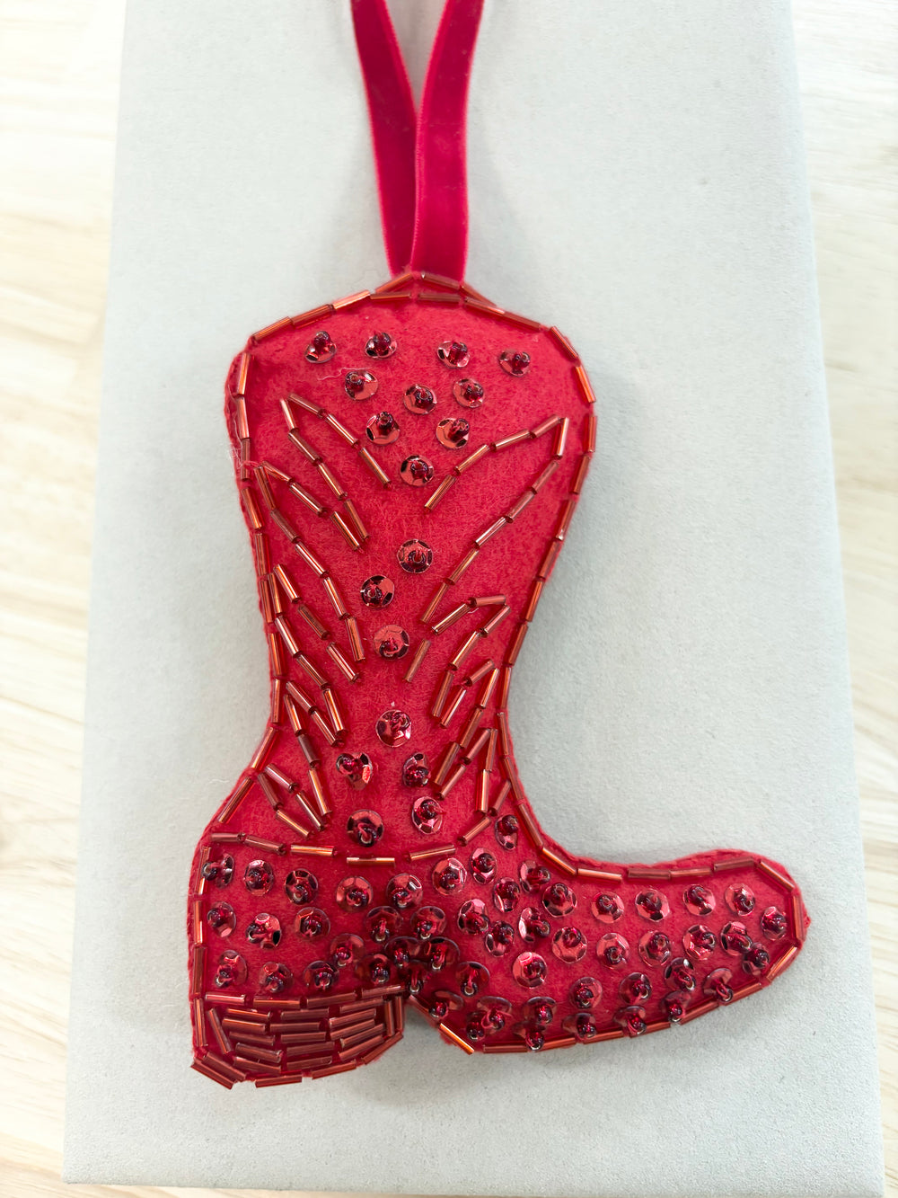 Red boot ornament with sequins and beads.