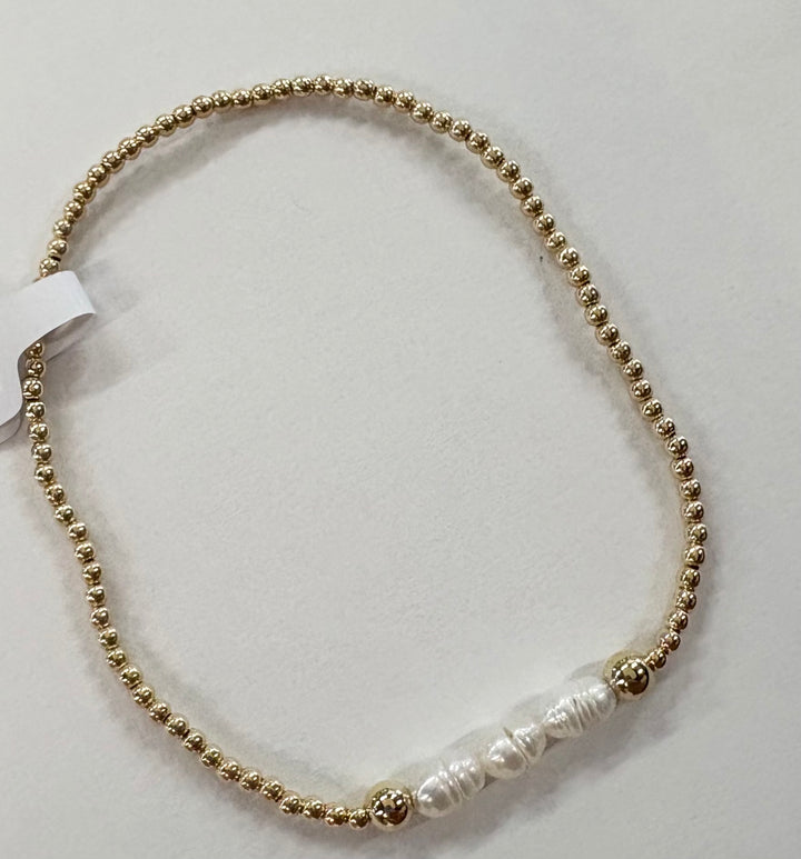 Glass bead bracelet with gold-filled beads and five white freshwater pearls.
