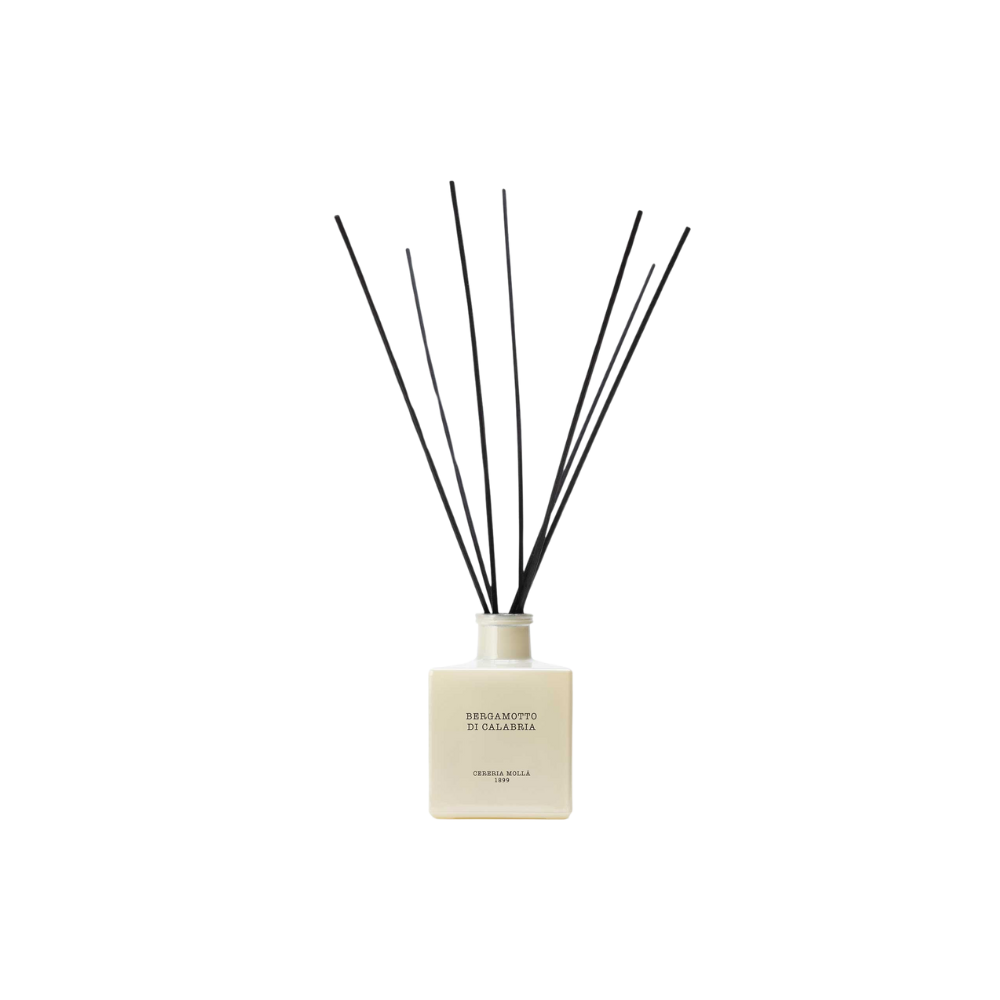 A white reed diffuser with black reeds, labeled "Bergamotto di Calabria."