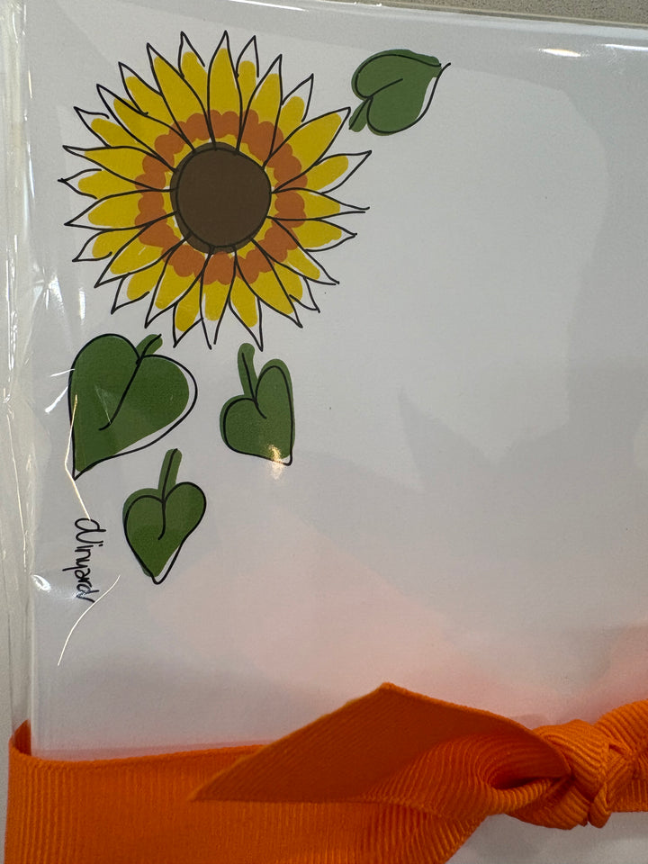 Sunflower notepad with an orange ribbon.