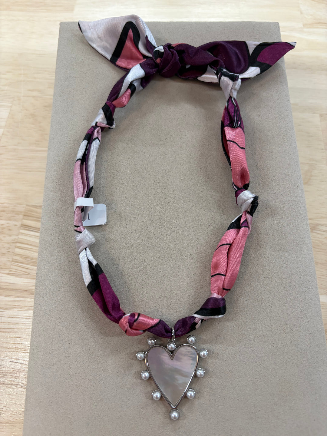 Annie Satin Scarf Necklace with a heart-shaped charm and pearls.