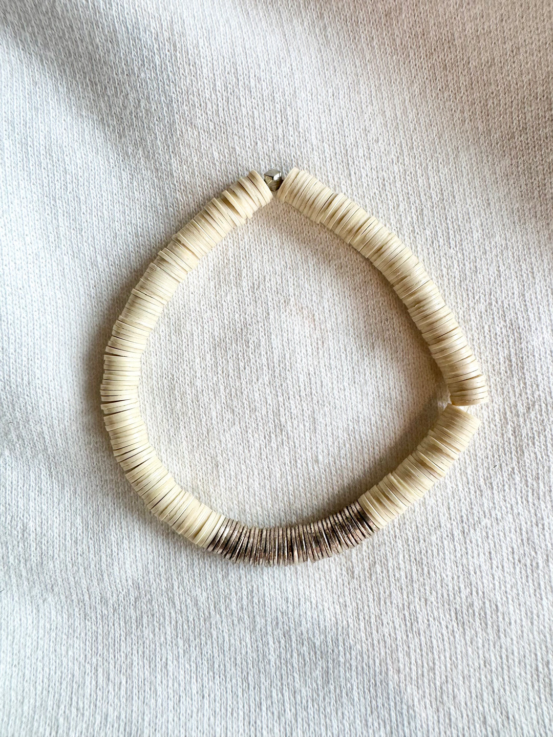 Large flat bead bracelet with white vinyl beads and a section of silver-plated beads.