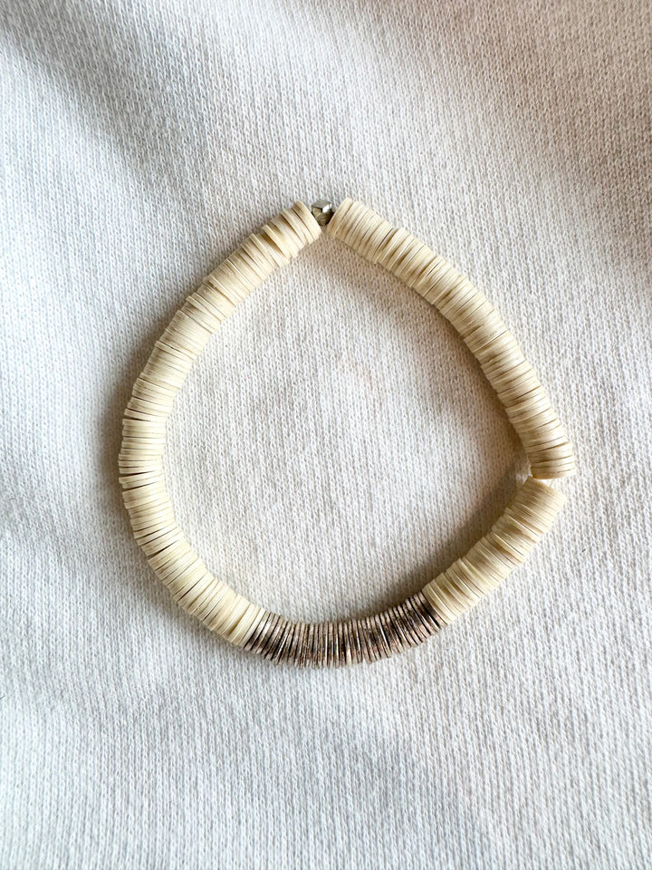 Large flat bead bracelet with white vinyl beads and a section of silver-plated beads.
