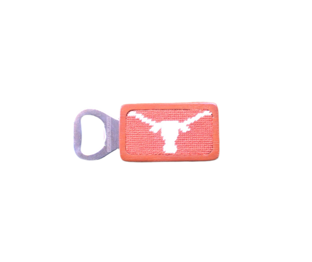 A University of Texas bottle opener with a white longhorn logo on an orange background.