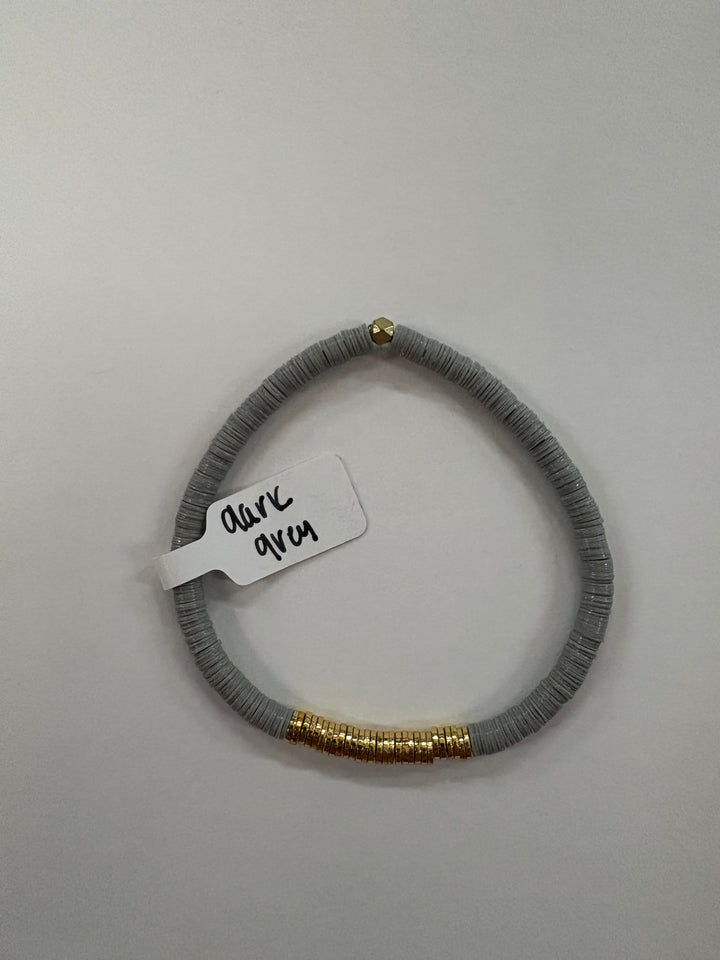 Small flat bead bracelet in dark grey with gold-plated accents.