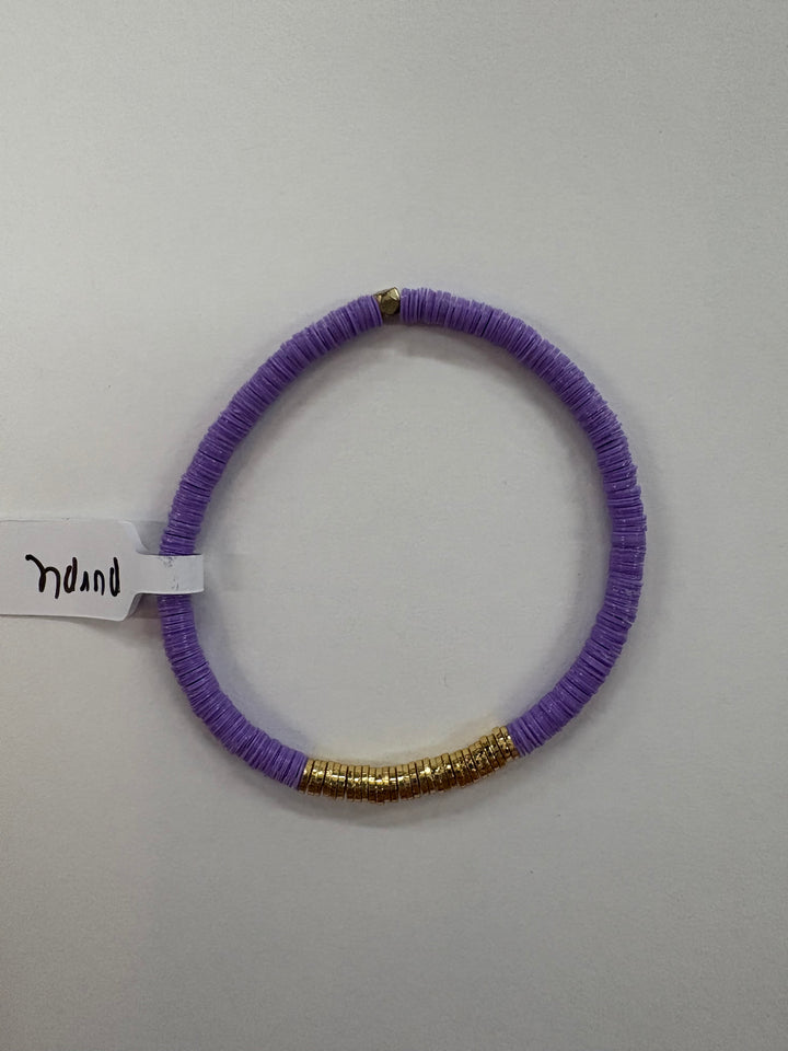 Purple flat bead bracelet with gold accents.