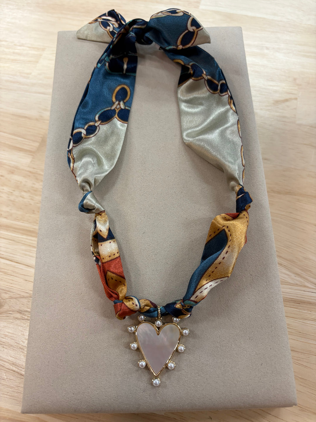 Laura Satin Scarf Necklace with a heart-shaped mother-of-pearl charm and pearl accents.