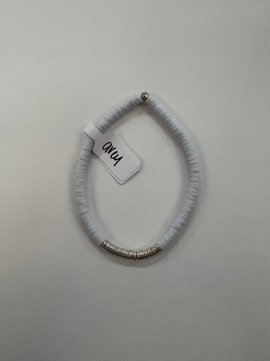 Small flat bead bracelet with silver rings and a silver bead.