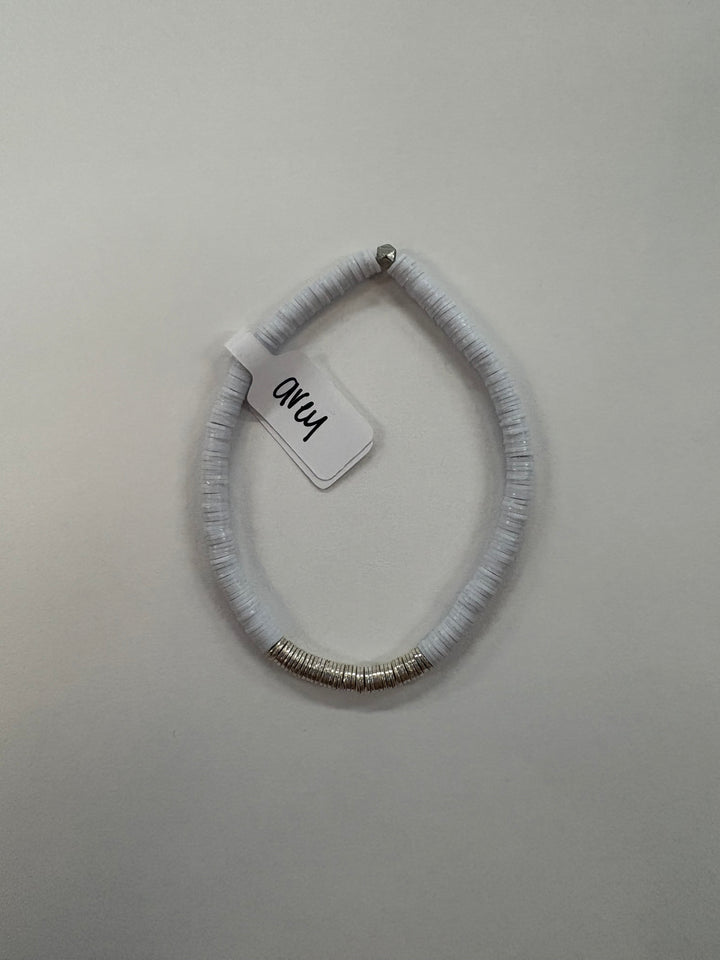 Small flat bead bracelet with silver rings and a silver bead.