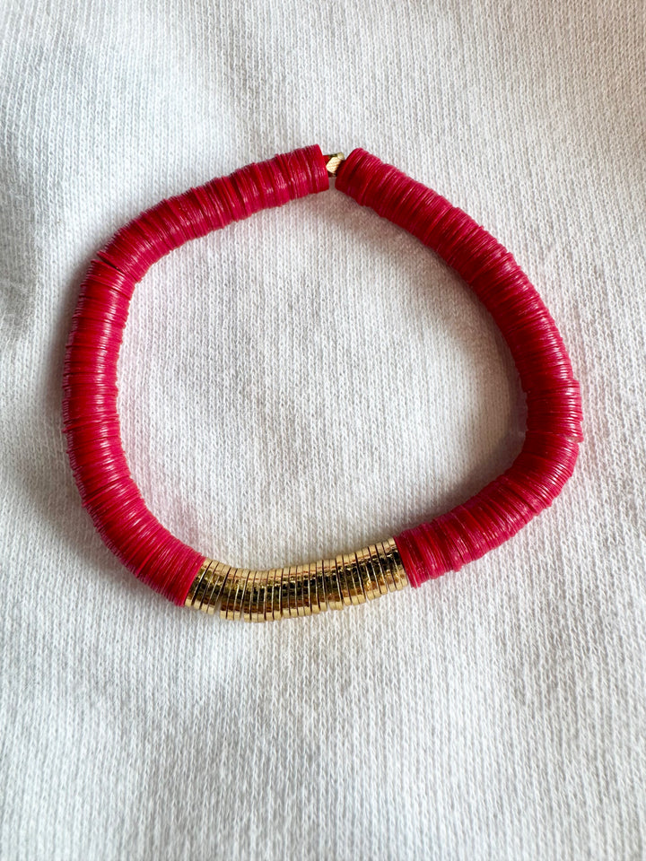 Large flat bead bracelet with red vinyl beads and a section of gold-plated beads.
