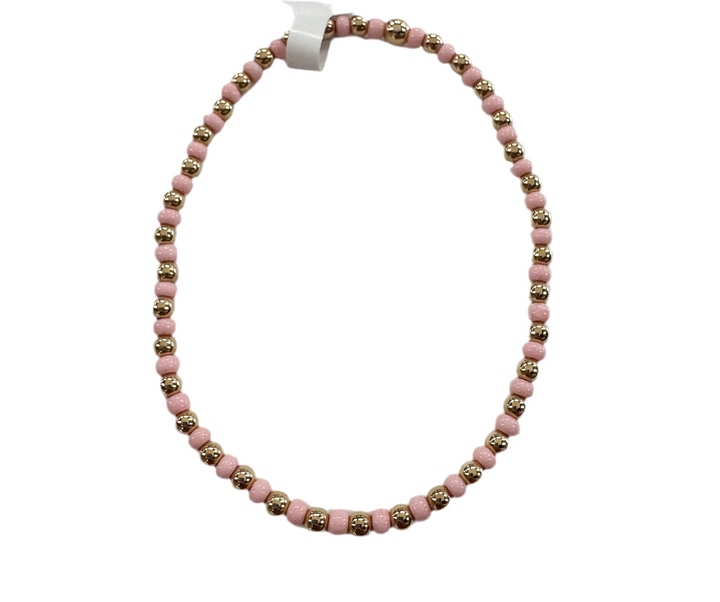 Glass bead bracelet with alternating pink and gold beads.
