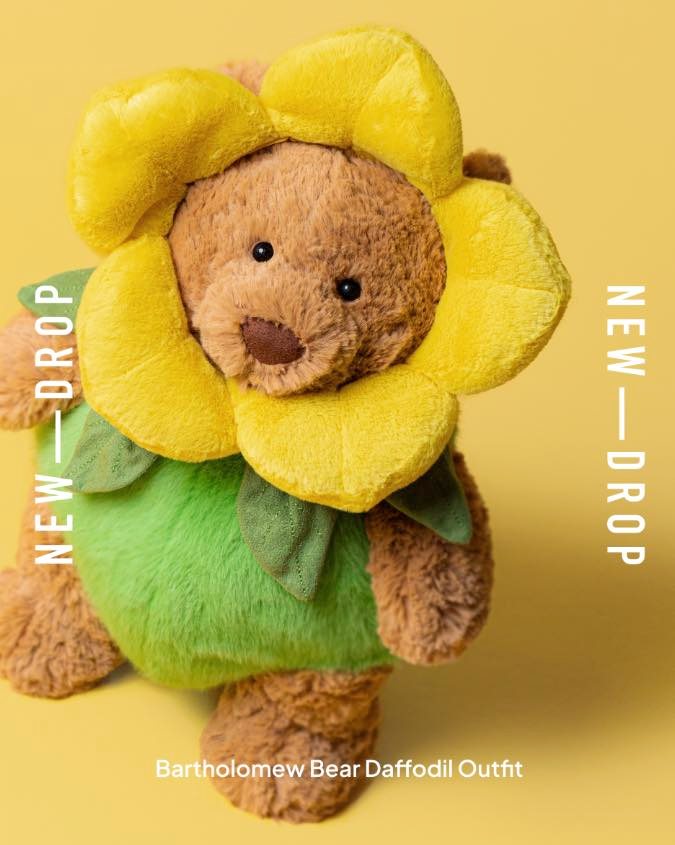 Bartholomew Bear in a yellow daffodil costume with green leaves.