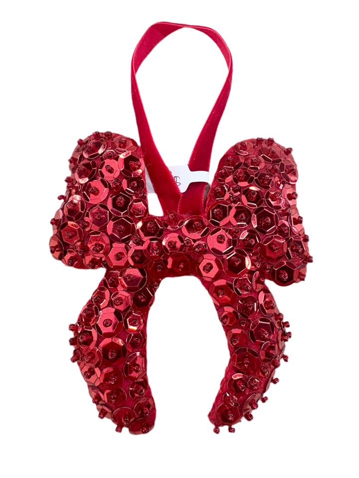 A large, red, hand-beaded bow ornament with a velvet hanging loop.
