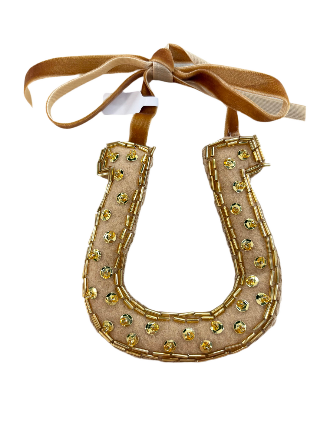 Hand-beaded horseshoe ornament with gold sequins and beads, tied with a brown velvet ribbon.