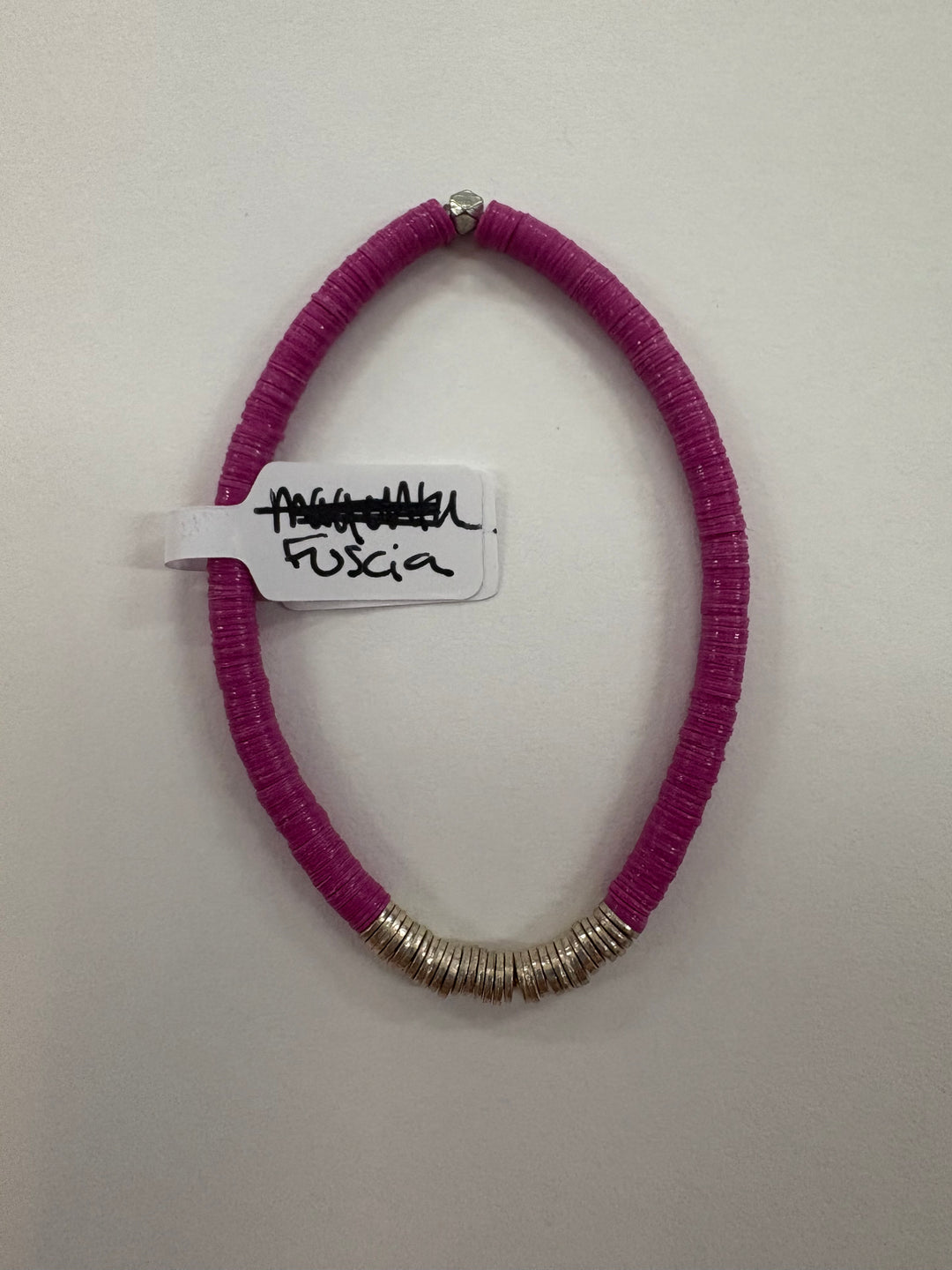 Small flat bead bracelet in fuscia with silver accents.