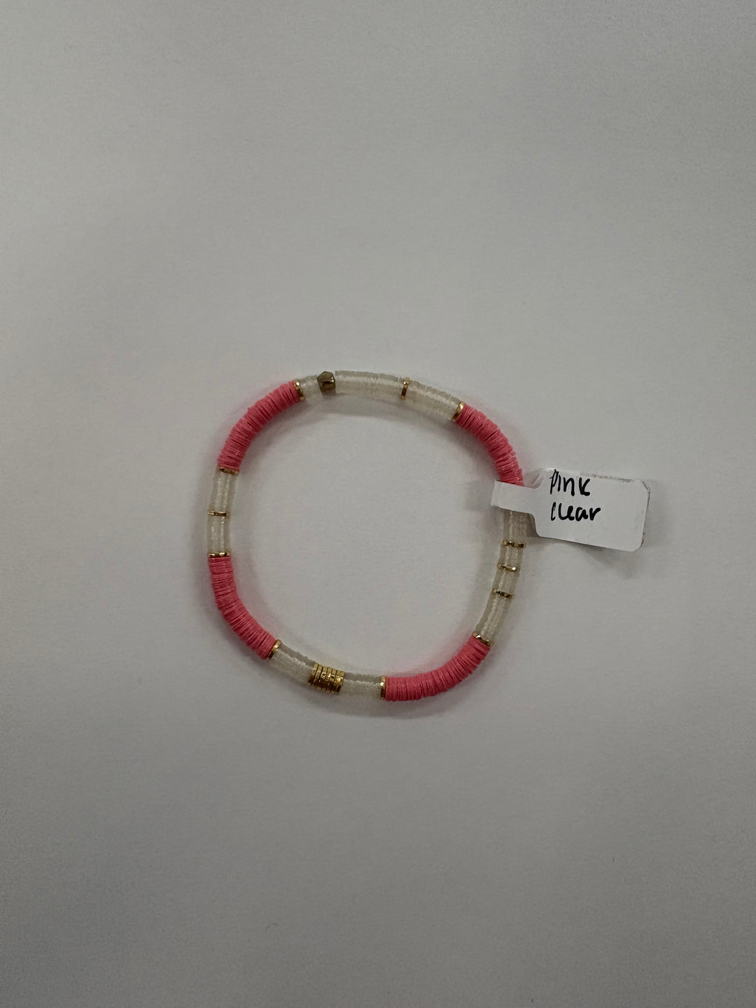 Small flat bead bracelet with pink and clear vinyl beads and gold accents.