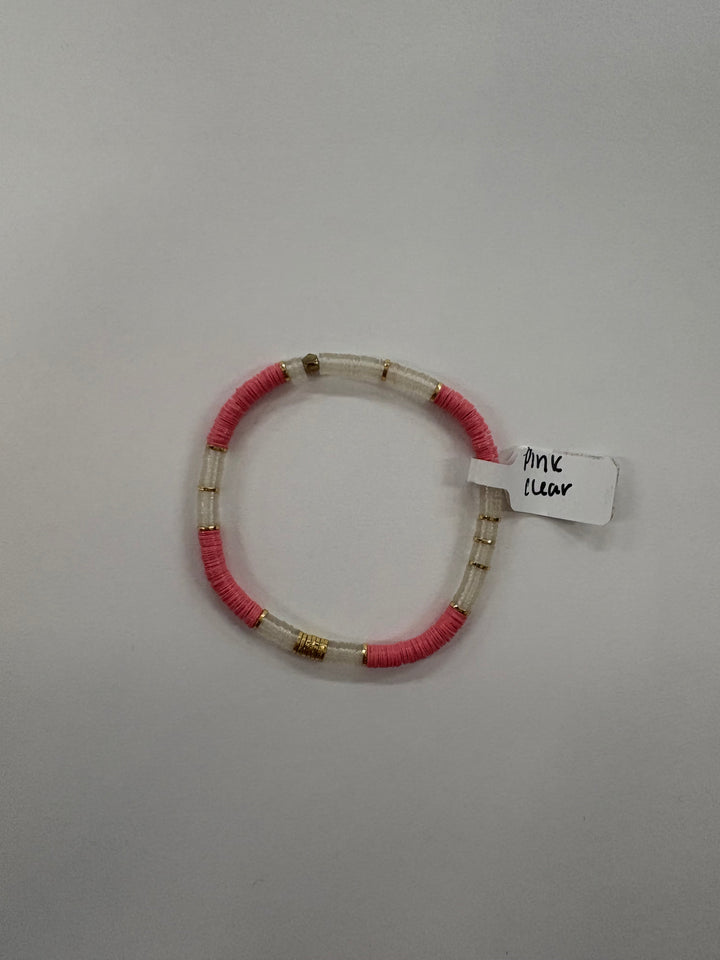 Small flat bead bracelet with pink and clear vinyl beads and gold accents.