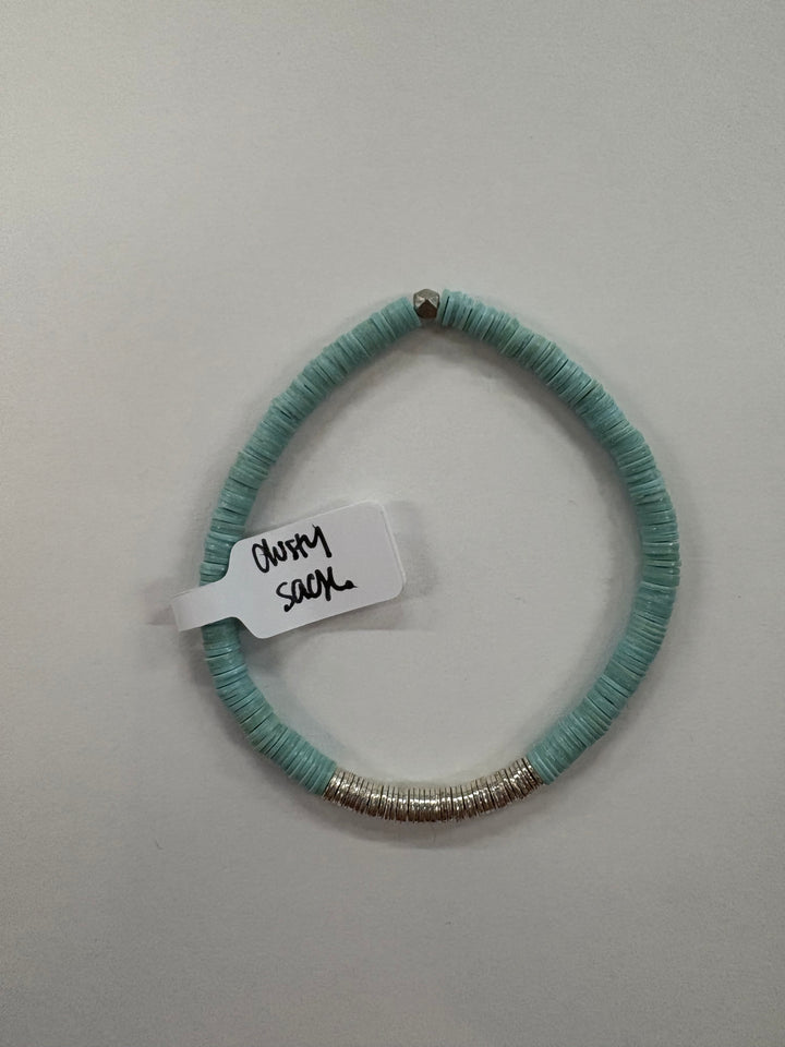 A light blue flat bead bracelet with a silver accent bead and a silver beaded section.