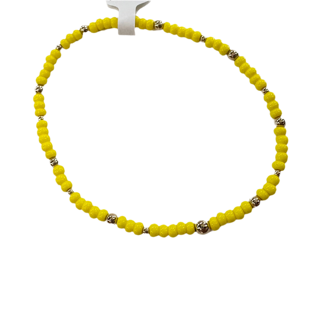 A yellow glass bead bracelet with silver accent beads.