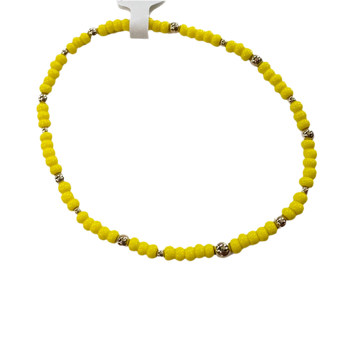A yellow glass bead bracelet with silver accent beads.