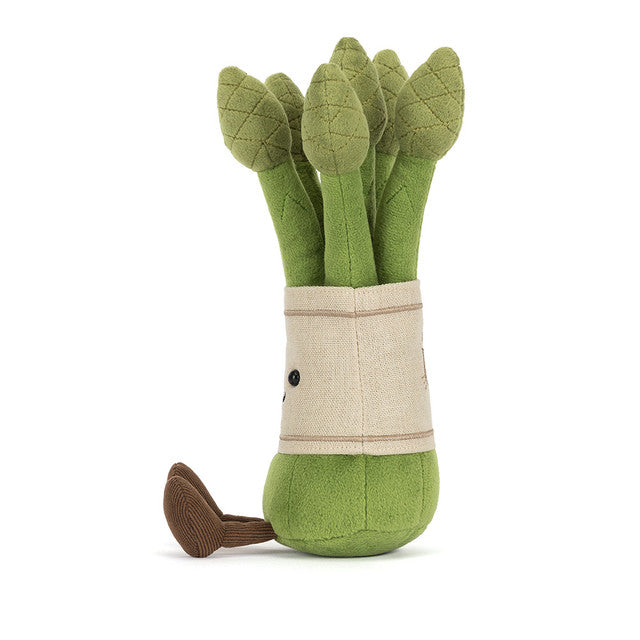 A plush toy asparagus with a fabric wrap and a brown foot.