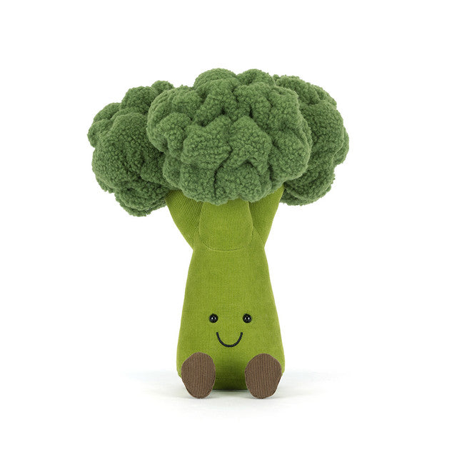 A plush broccoli toy with a smiling face and brown feet.