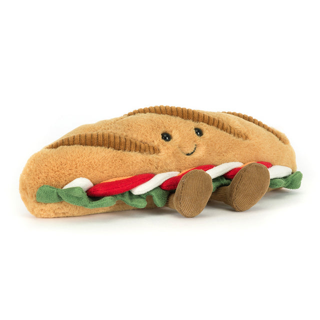 A plush caprese baguette toy with a smiling face and fabric legs.