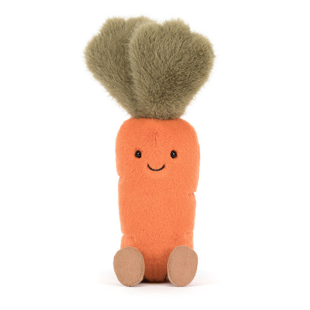 A plush carrot toy with green leafy hair and a smiling face.
