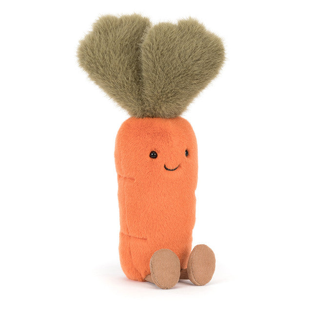 A plush carrot toy with green leafy hair and a smiling face.