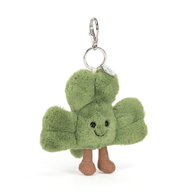 A green shamrock plush bag charm with brown boots and a silver clasp.