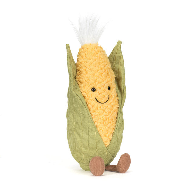 A plush toy corn cob with a smiling face and green husk.