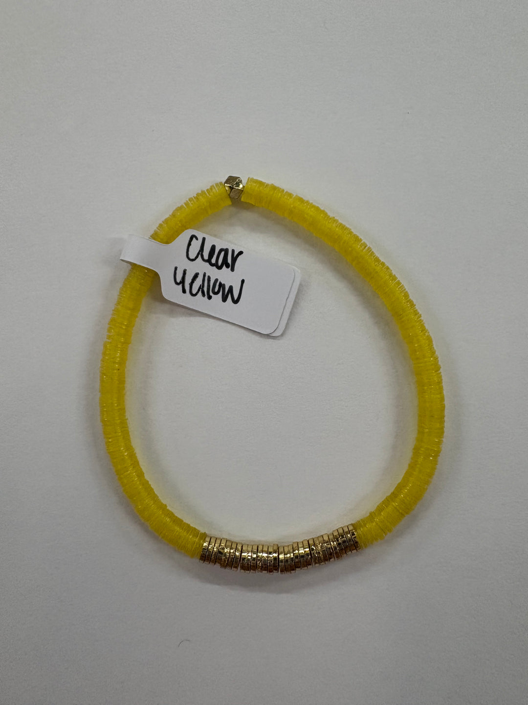 Small flat bead bracelet with clear yellow vinyl beads and gold-plated accents.