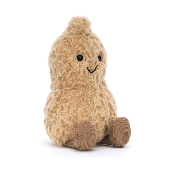 A plush peanut toy with a smiling face and corduroy feet sits on a white background.