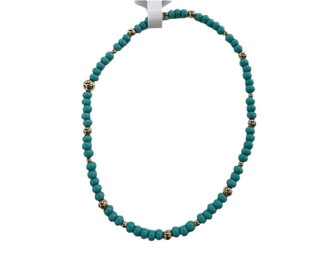 Glass bead bracelet with alternating teal beads and gold-colored accent beads.