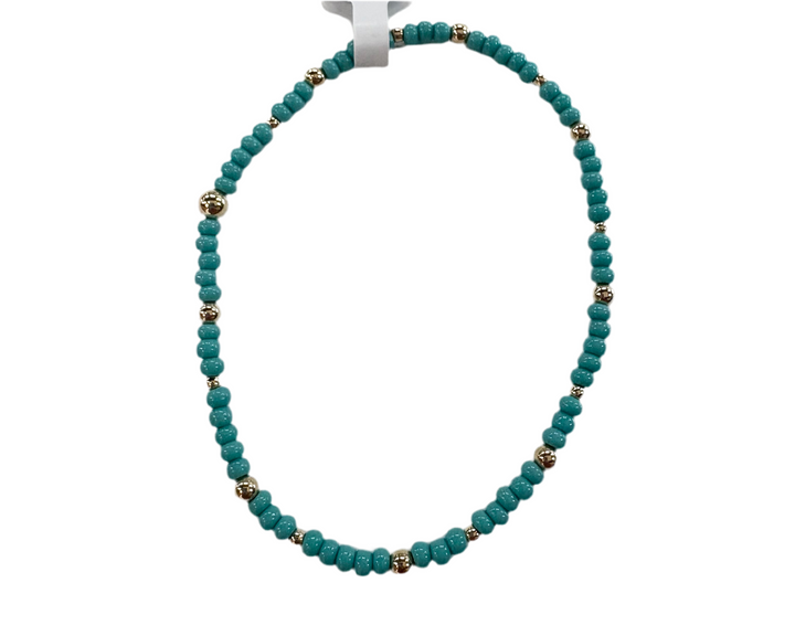 Glass bead bracelet with alternating teal beads and gold-colored accent beads.