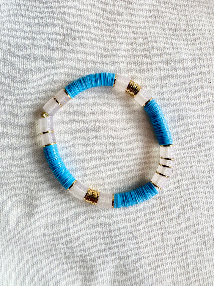 Large flat bead bracelet with blue and white vinyl beads and gold accents.