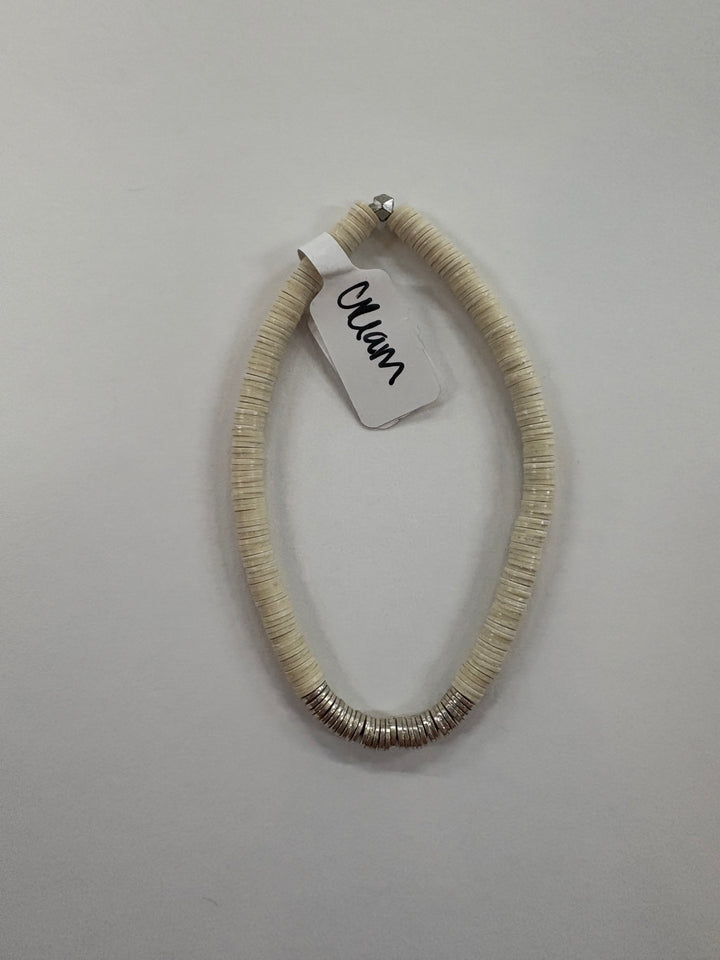 Small flat bead bracelet with a "Cream" tag and silver-toned accents.