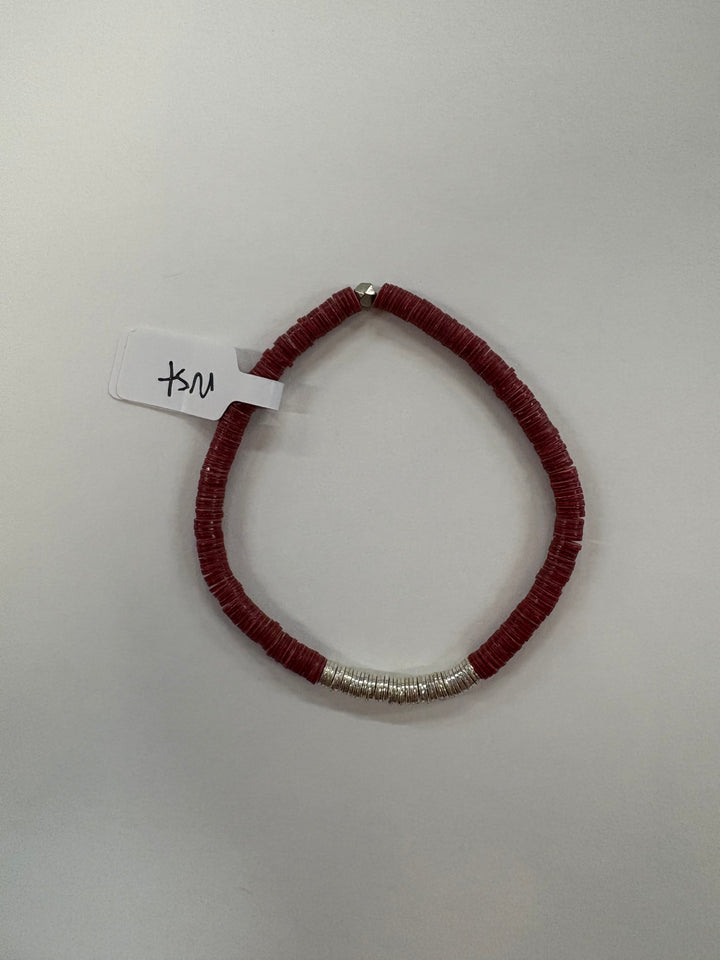 A small flat bead bracelet with red beads and a section of silver beads.