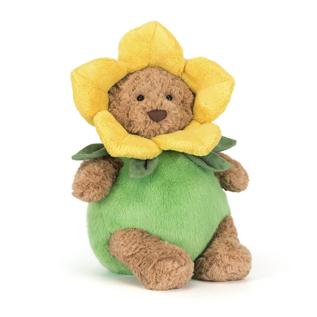 A brown teddy bear wears a yellow daffodil costume with green leaves.