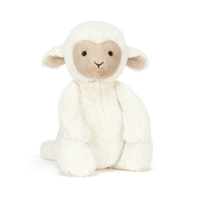 A fluffy white lamb stuffed animal with a tan face and ears.